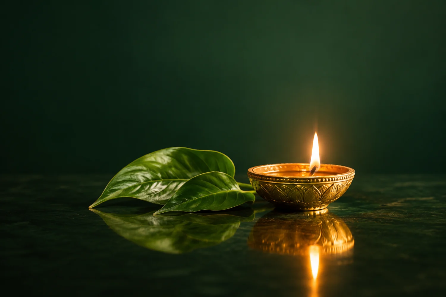 A small diya glowing beside leaves